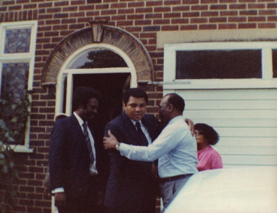 Muhammad Ali greeting Bishop Dunn outside a house